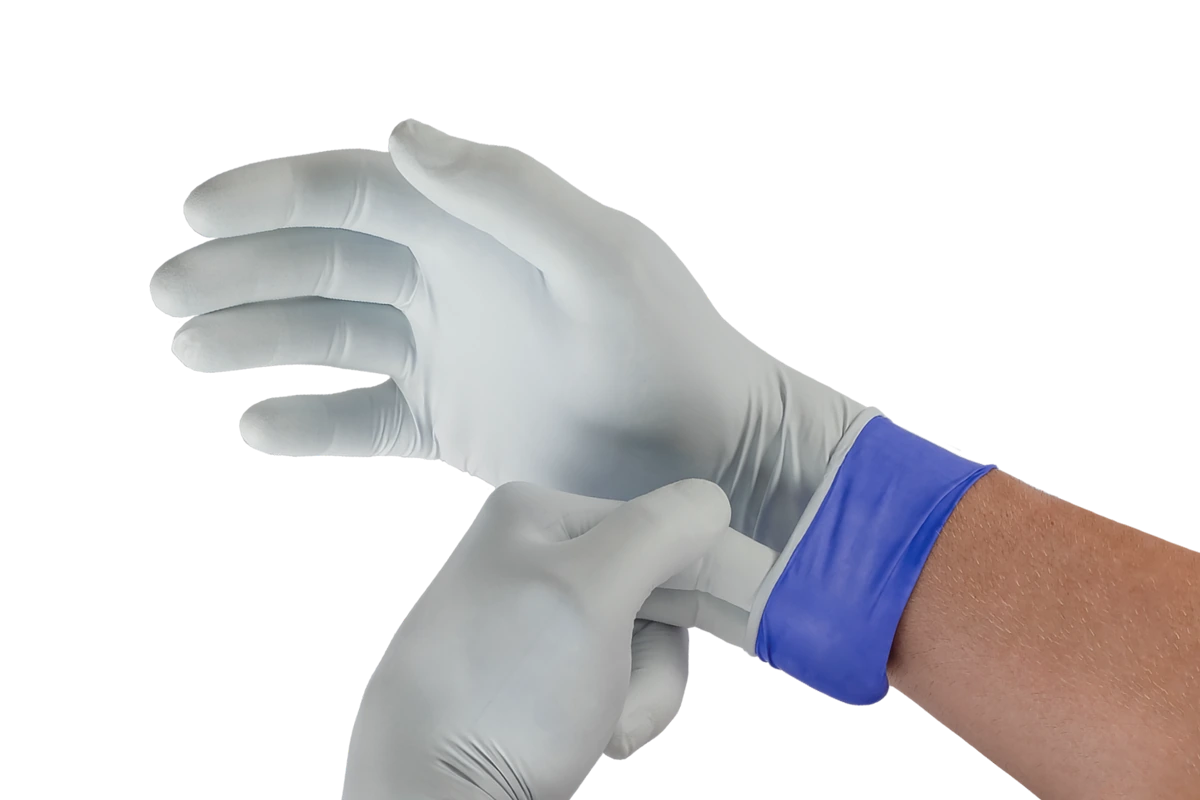 A provider pulling on a pair of examination gloves